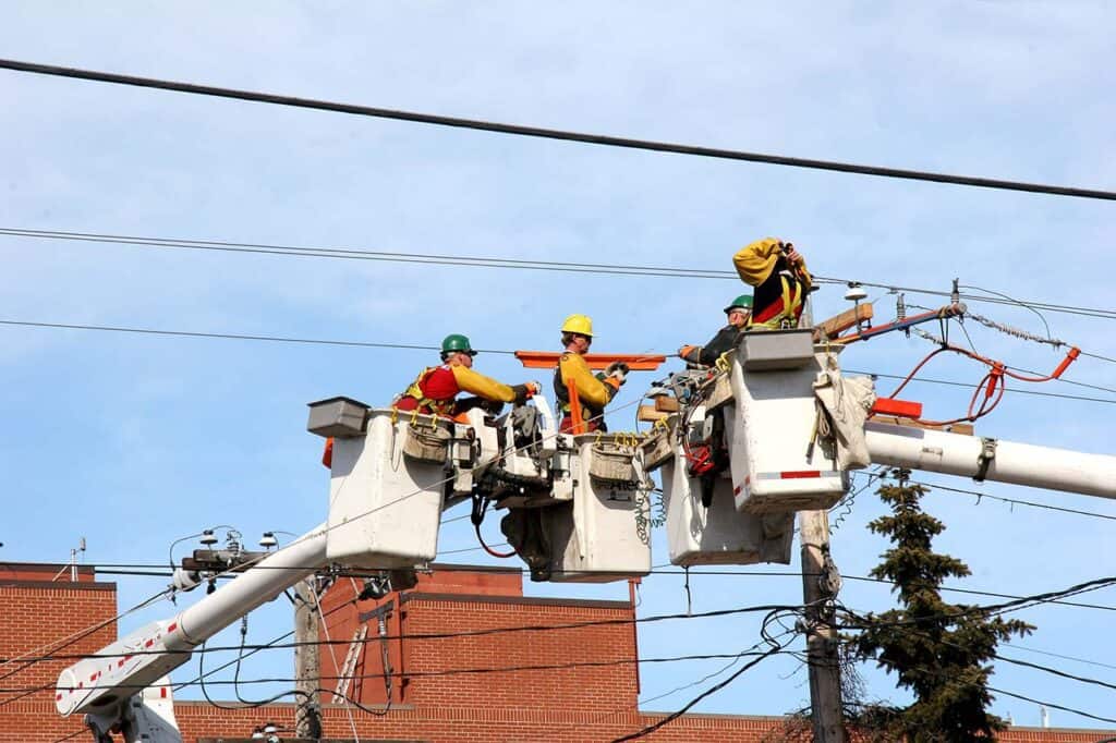 Link Resources work as a safety observer spotter workers monitoring overhead powerline maintenance